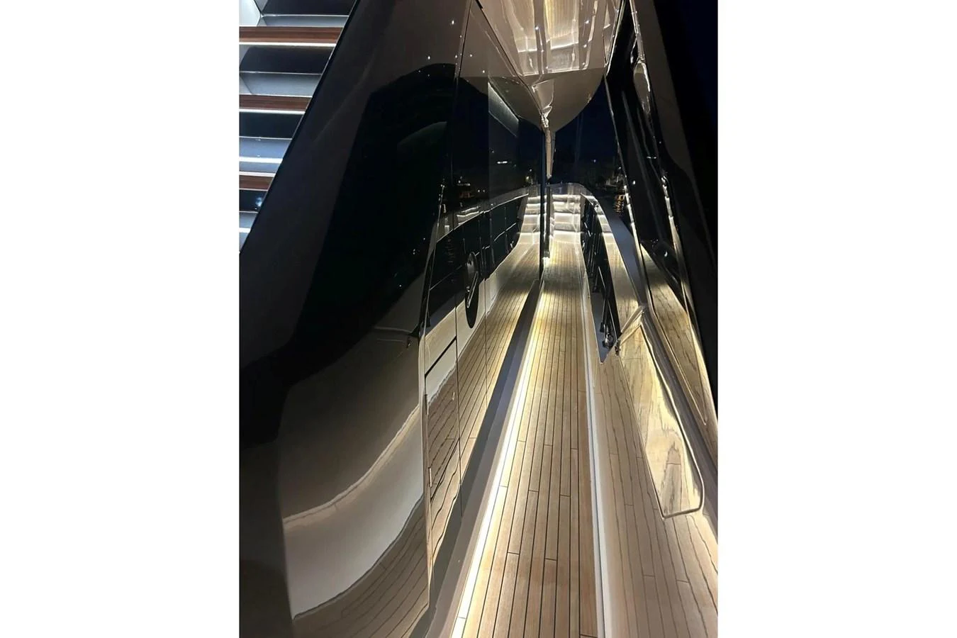 A sleek and modern side deck with ambient lighting and polished surfaces. aboard SAVIENNE Yacht for Sale
