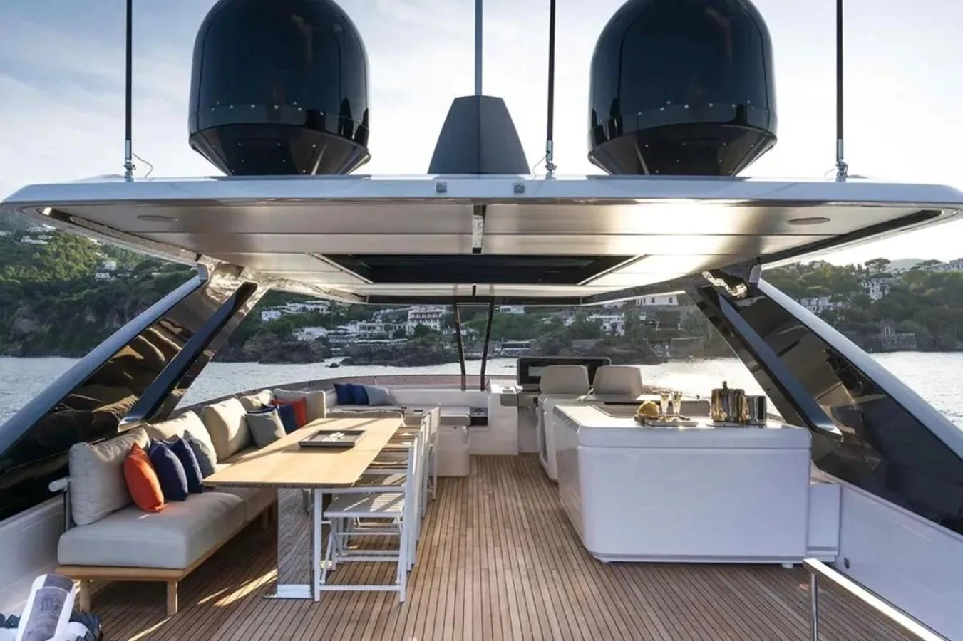 The aft deck features a spacious seating area with a dining table and modern amenities, perfect for outdoor relaxation and entertainment. aboard SAVIENNE Yacht for Sale