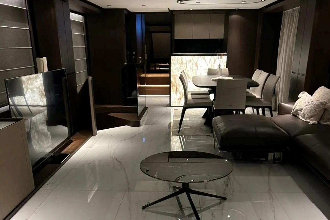 The salon features a modern design with luxurious furnishings and elegant lighting. aboard SAVIENNE Yacht for Sale