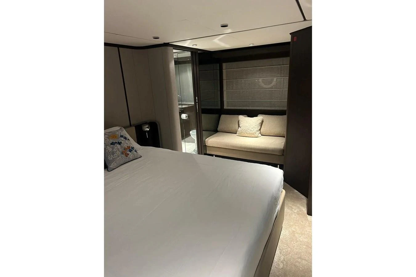 The stateroom offers a cozy and elegant space with a comfortable bed and a small seating area. aboard SAVIENNE Yacht for Sale