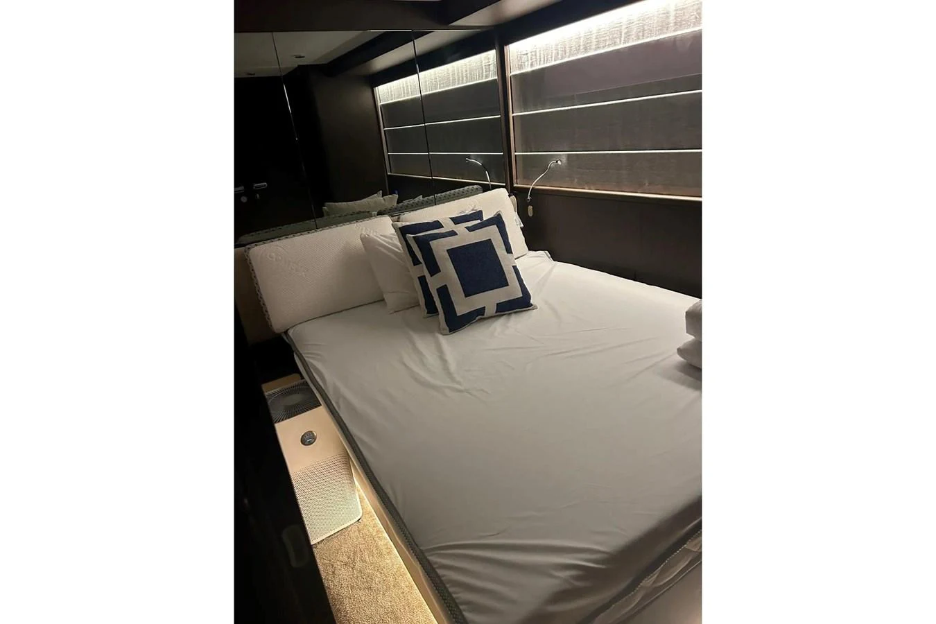 A cozy stateroom with a neatly made bed and modern decor. aboard SAVIENNE Yacht for Sale