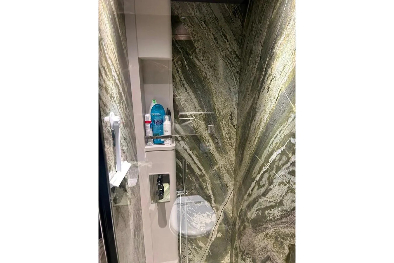 The yacht's bathroom features luxurious marble walls and modern fixtures. aboard SAVIENNE Yacht for Sale