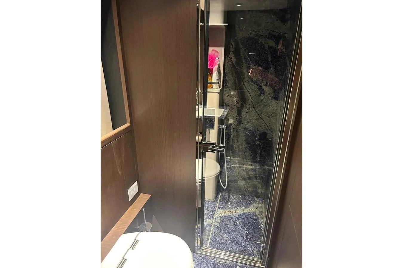 A modern yacht bathroom featuring a glass-enclosed shower and sleek fixtures. aboard SAVIENNE Yacht for Sale