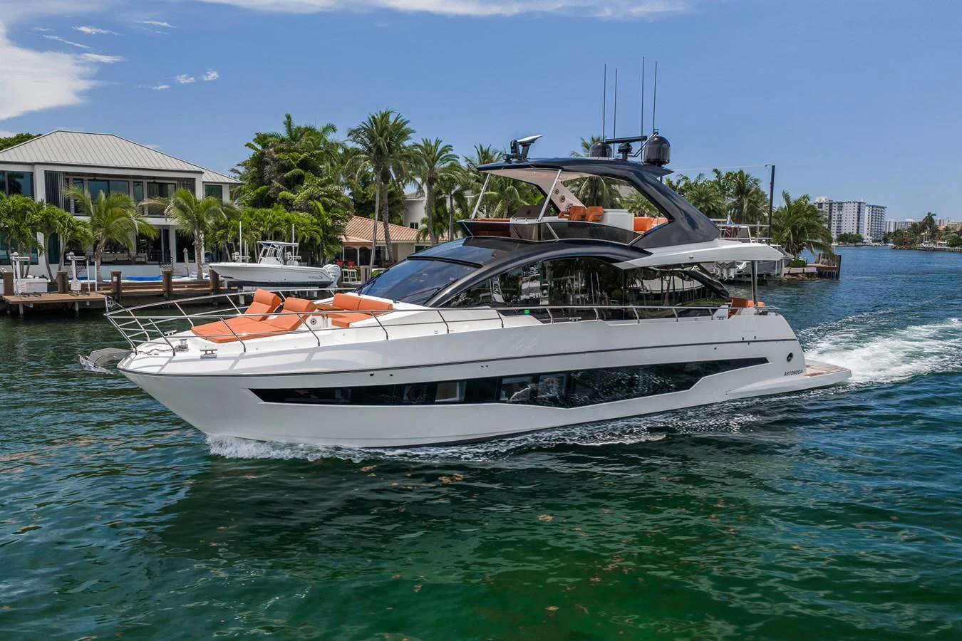 A sleek and modern yacht cruises through a serene waterway, showcasing its elegant design and luxurious amenities. aboard ELENA Yacht for Sale