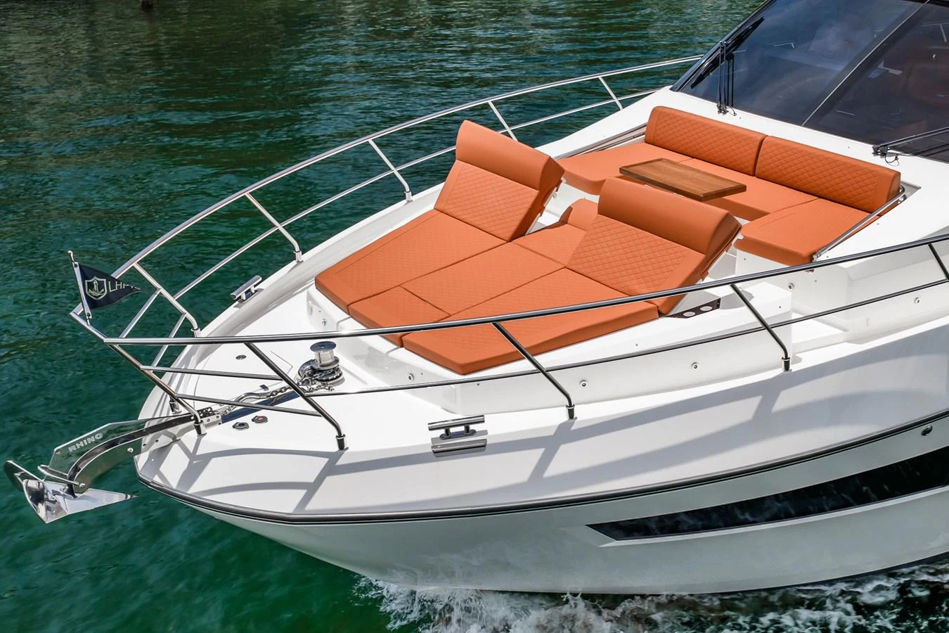 The yacht's foredeck features luxurious sun loungers with vibrant orange cushions, perfect for relaxation. aboard ELENA Yacht for Sale