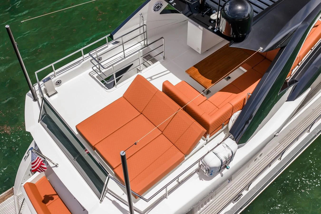 The yacht's sundeck features plush orange loungers and a sleek design, perfect for relaxation. aboard ELENA Yacht for Sale