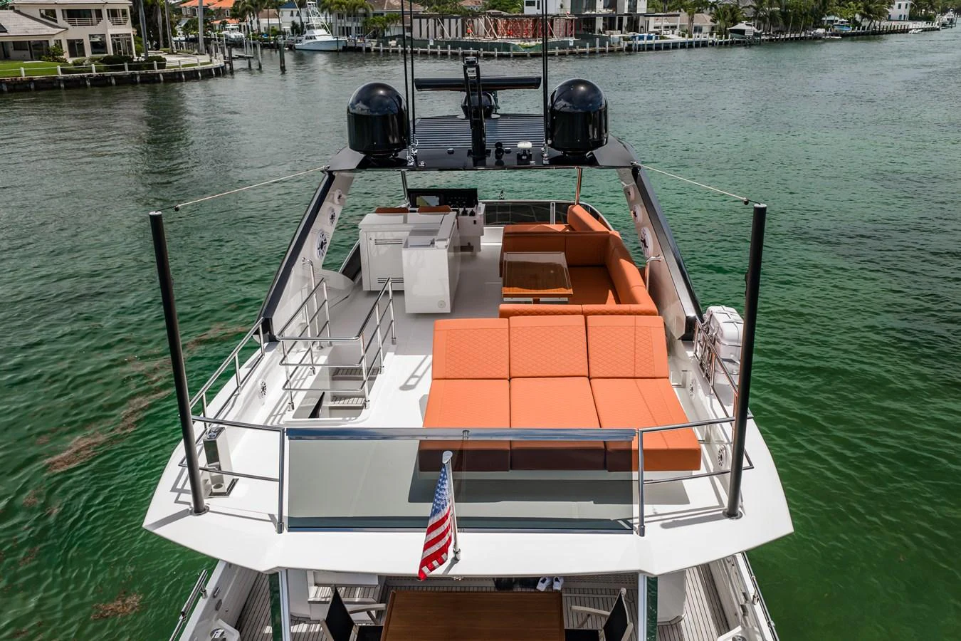 The yacht's sundeck features a spacious lounging area with vibrant orange cushions, perfect for relaxation. aboard ELENA Yacht for Sale