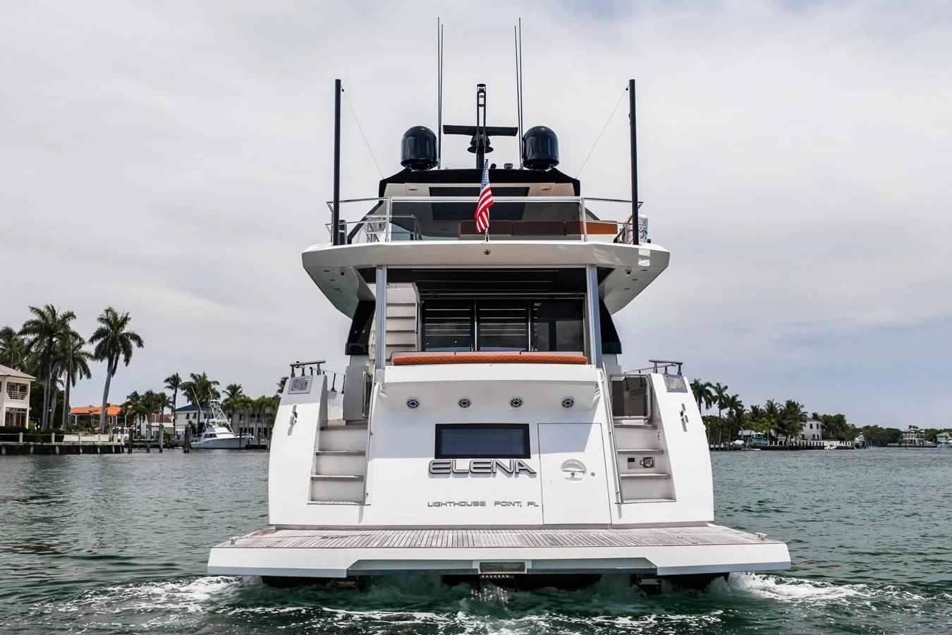 The yacht is captured from the stern, showcasing its sleek design and spacious deck area. aboard ELENA Yacht for Sale