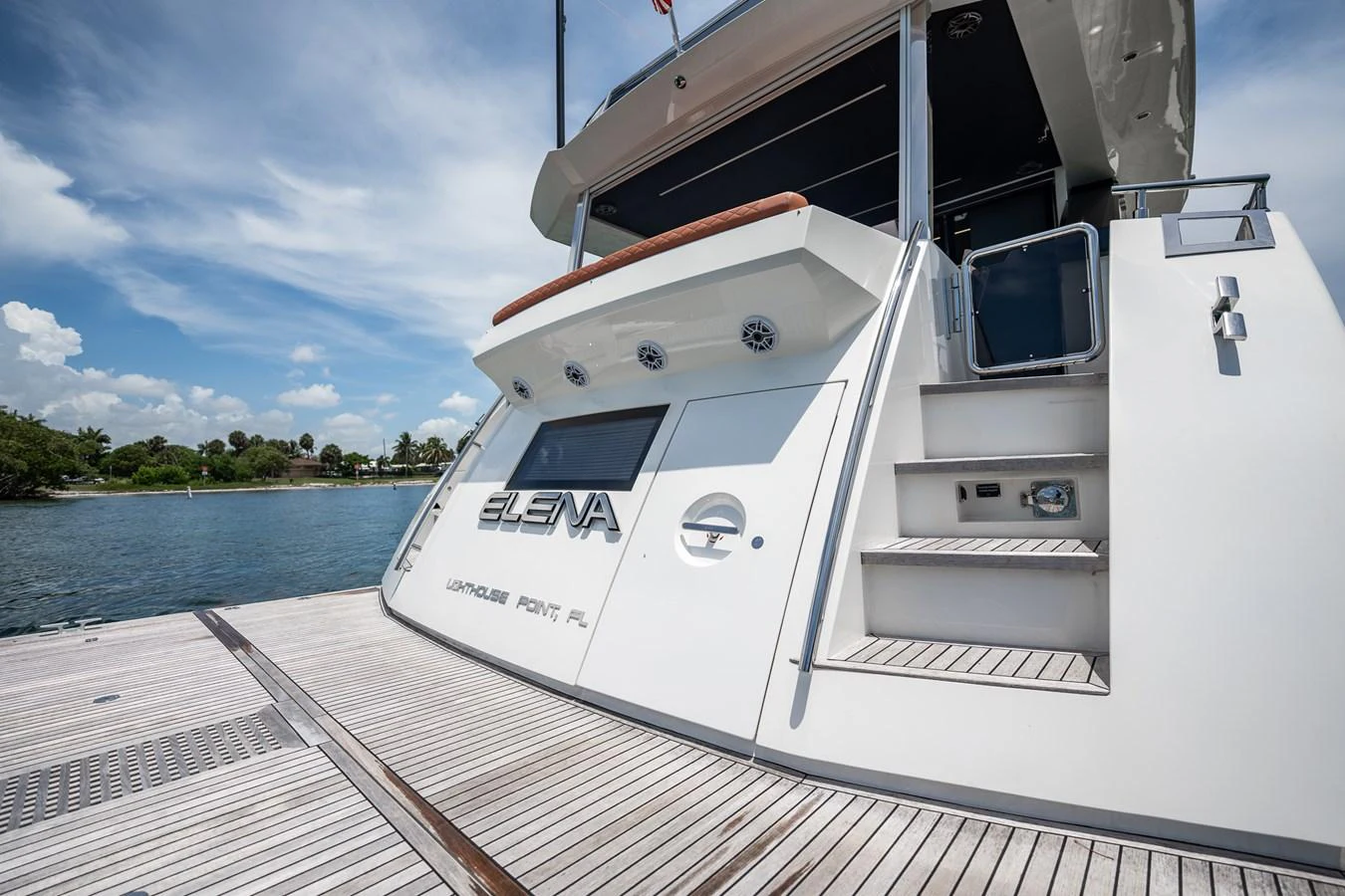 The yacht is docked, showcasing its sleek stern and inviting boarding steps. aboard ELENA Yacht for Sale