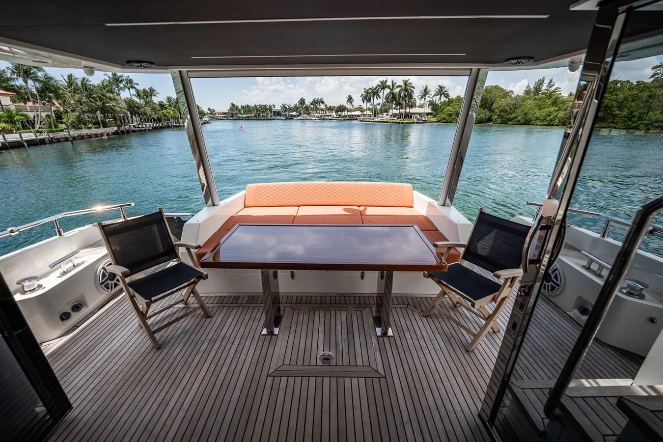 The aft deck offers a serene dining area with a stunning view of the water. aboard ELENA Yacht for Sale
