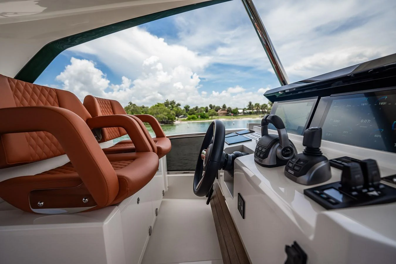 The helm station features luxurious seating and advanced navigation equipment with a scenic view. aboard ELENA Yacht for Sale