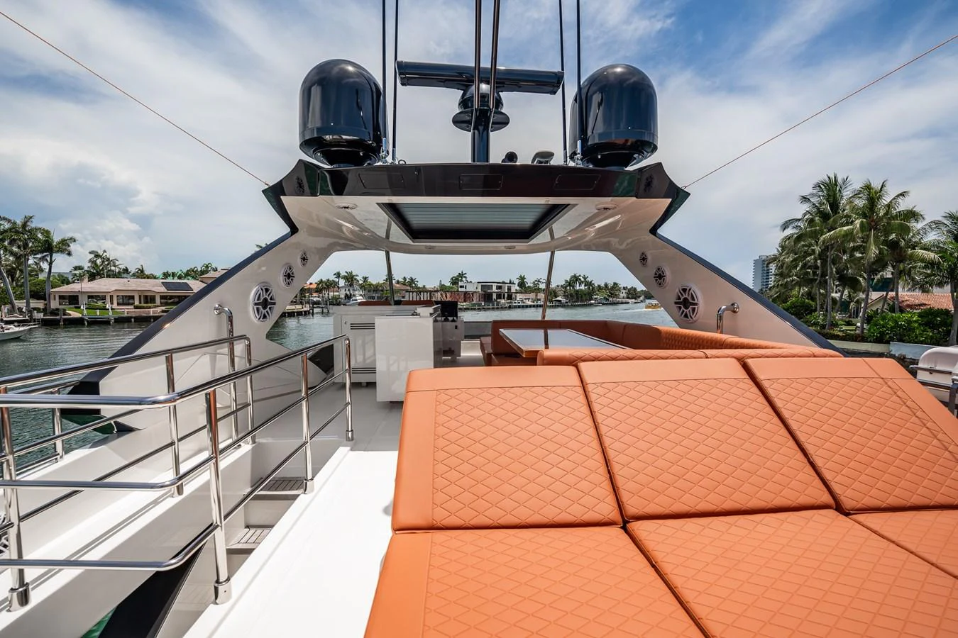 The flybridge features a spacious sunbathing area with luxurious orange cushions and a sleek, modern design. aboard ELENA Yacht for Sale