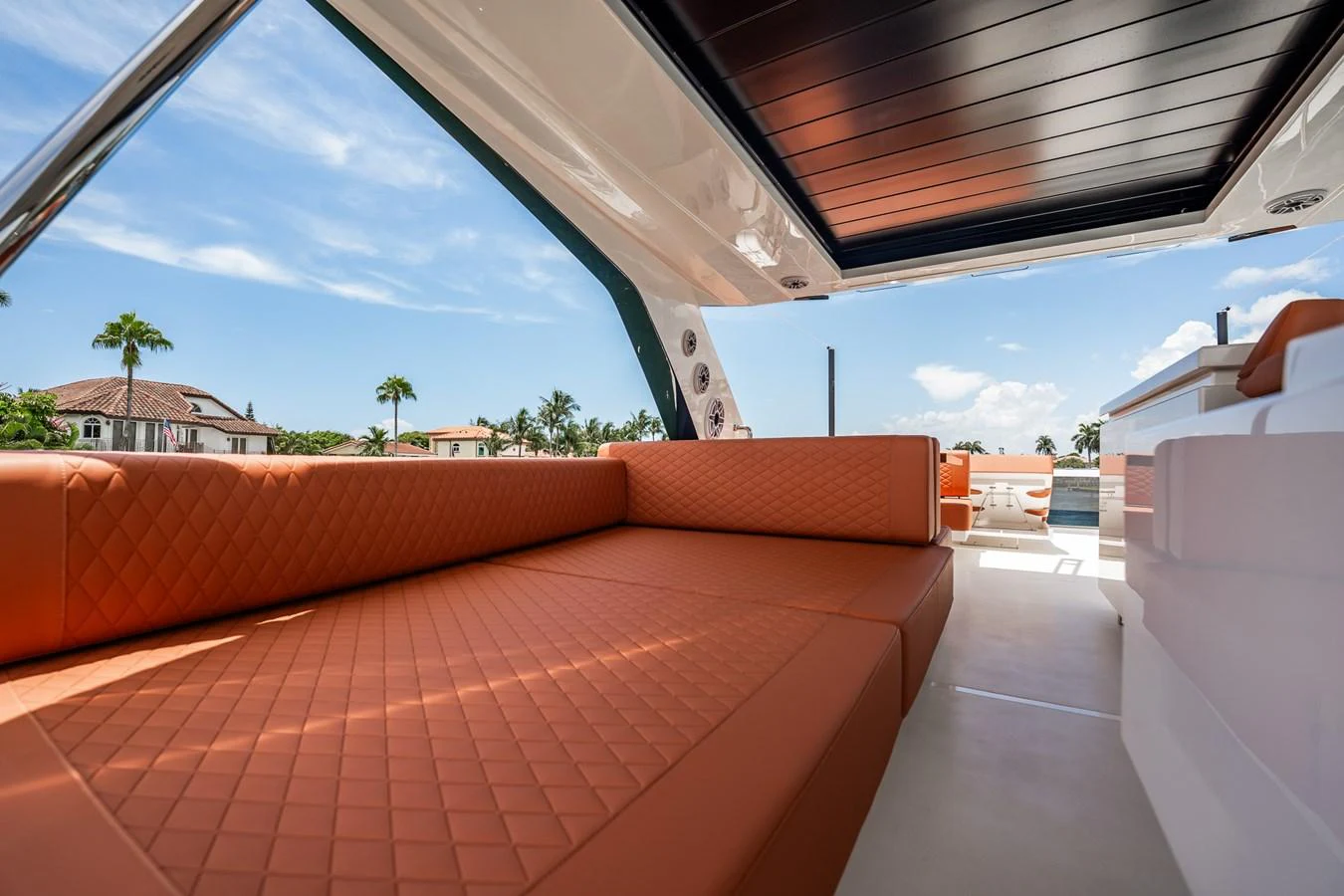 The sundeck features luxurious quilted seating with a retractable roof, perfect for relaxation. aboard ELENA Yacht for Sale