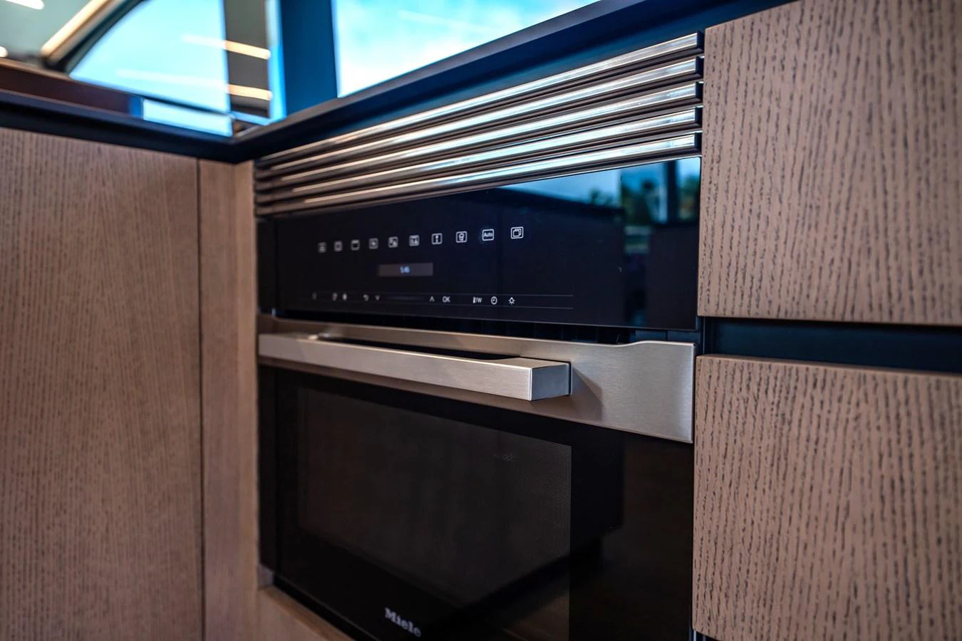 A sleek, modern galley features high-end appliances and stylish wood cabinetry. aboard ELENA Yacht for Sale
