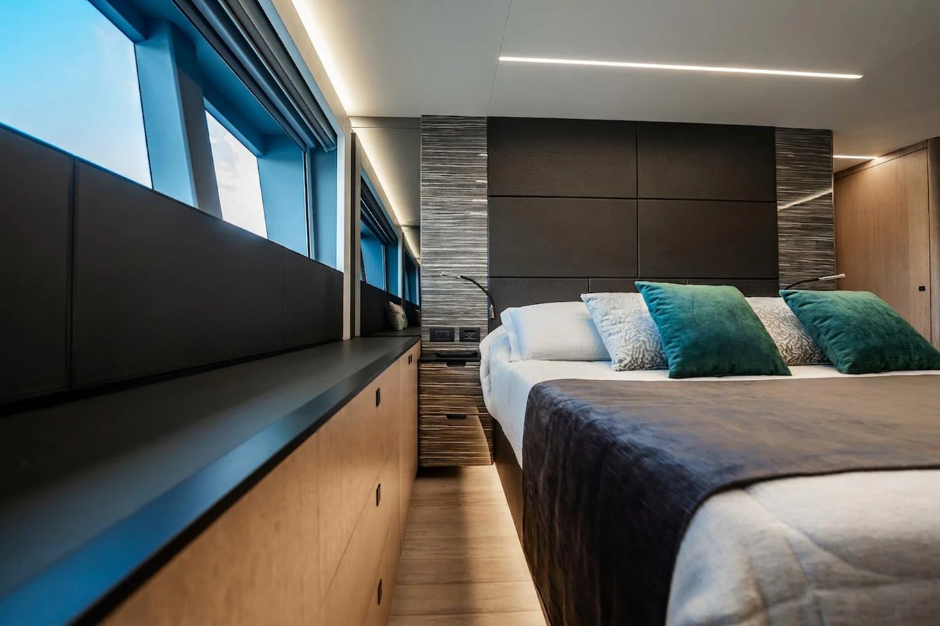 The stateroom features a modern design with large windows and luxurious bedding. aboard ELENA Yacht for Sale