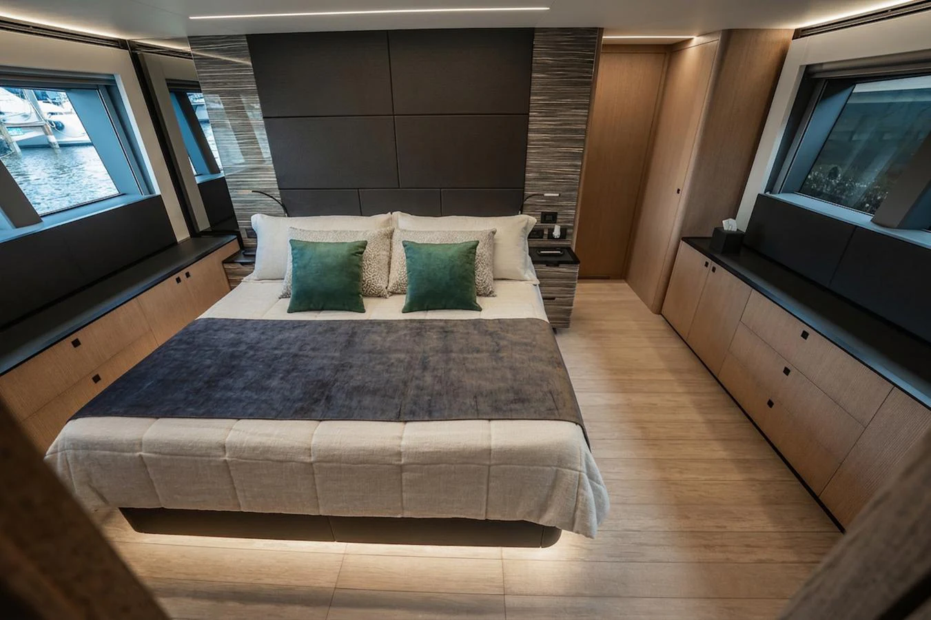 The master stateroom features a luxurious bed with elegant decor and ample natural light from large windows. aboard ELENA Yacht for Sale
