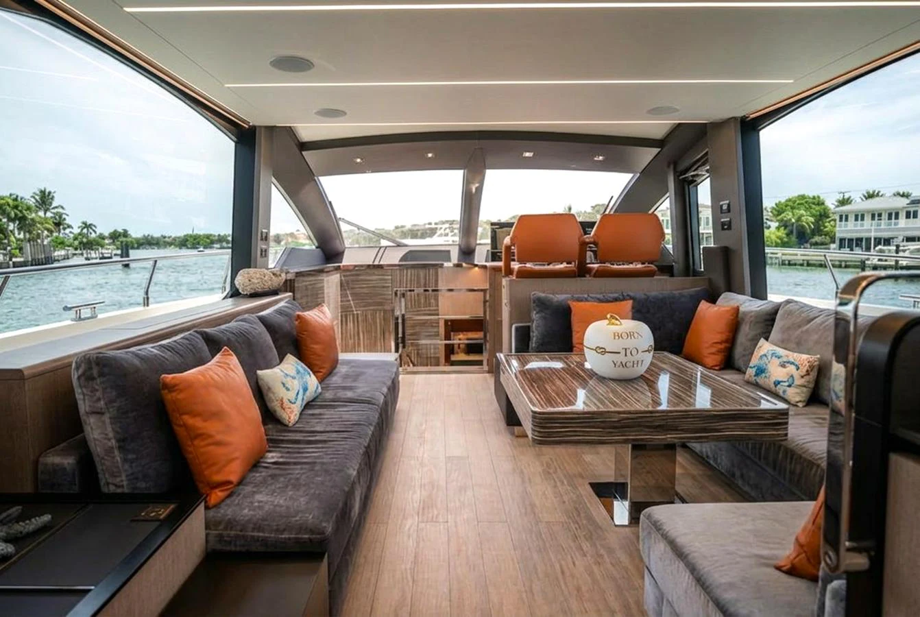 The salon features plush seating, a stylish coffee table, and large windows offering panoramic views. aboard ELENA Yacht for Sale