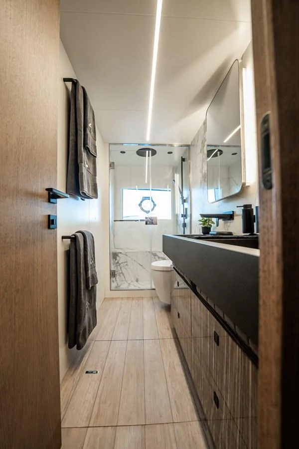 The yacht's bathroom features modern fixtures and a sleek design, providing a luxurious and comfortable space. aboard ELENA Yacht for Sale