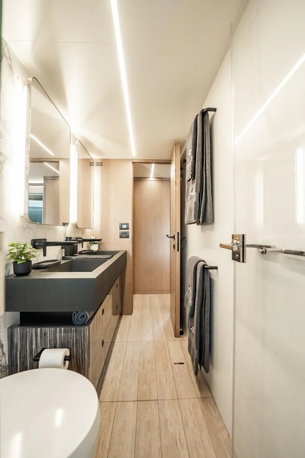A modern yacht bathroom featuring sleek fixtures and contemporary design. aboard ELENA Yacht for Sale