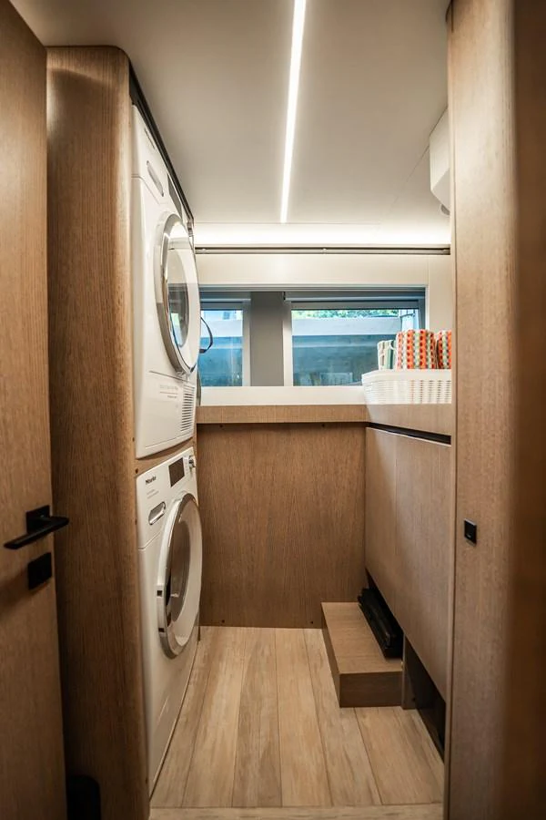 The yacht features a compact and efficient laundry room with modern appliances. aboard ELENA Yacht for Sale