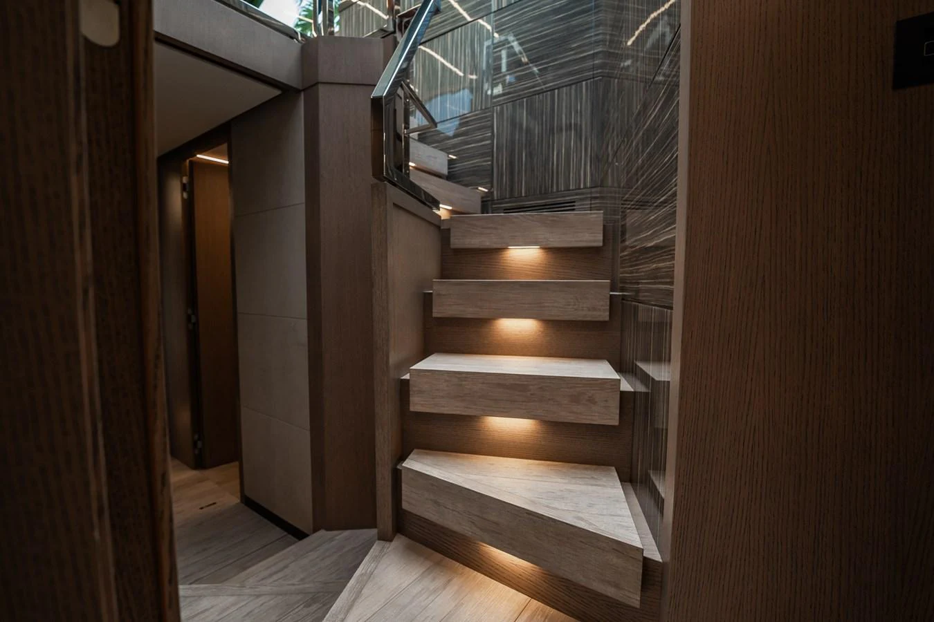 A modern staircase with ambient lighting leads to the upper deck. aboard ELENA Yacht for Sale