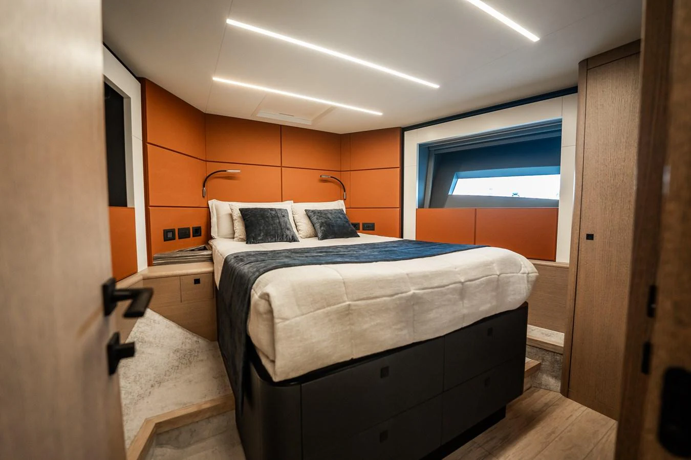 A luxurious stateroom featuring a comfortable bed with modern lighting and stylish decor. aboard ELENA Yacht for Sale