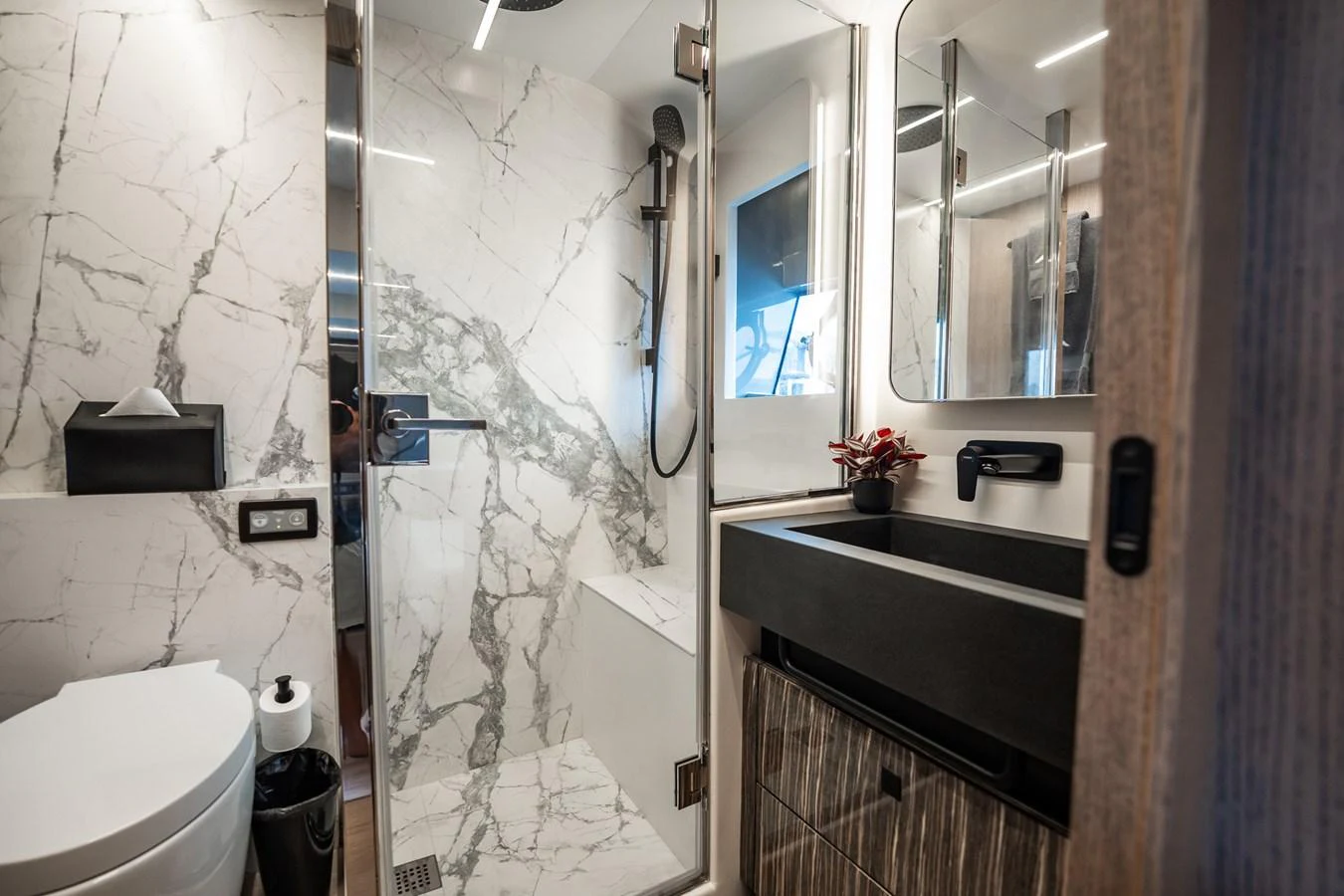 The yacht's bathroom features luxurious marble finishes and modern fixtures. aboard ELENA Yacht for Sale