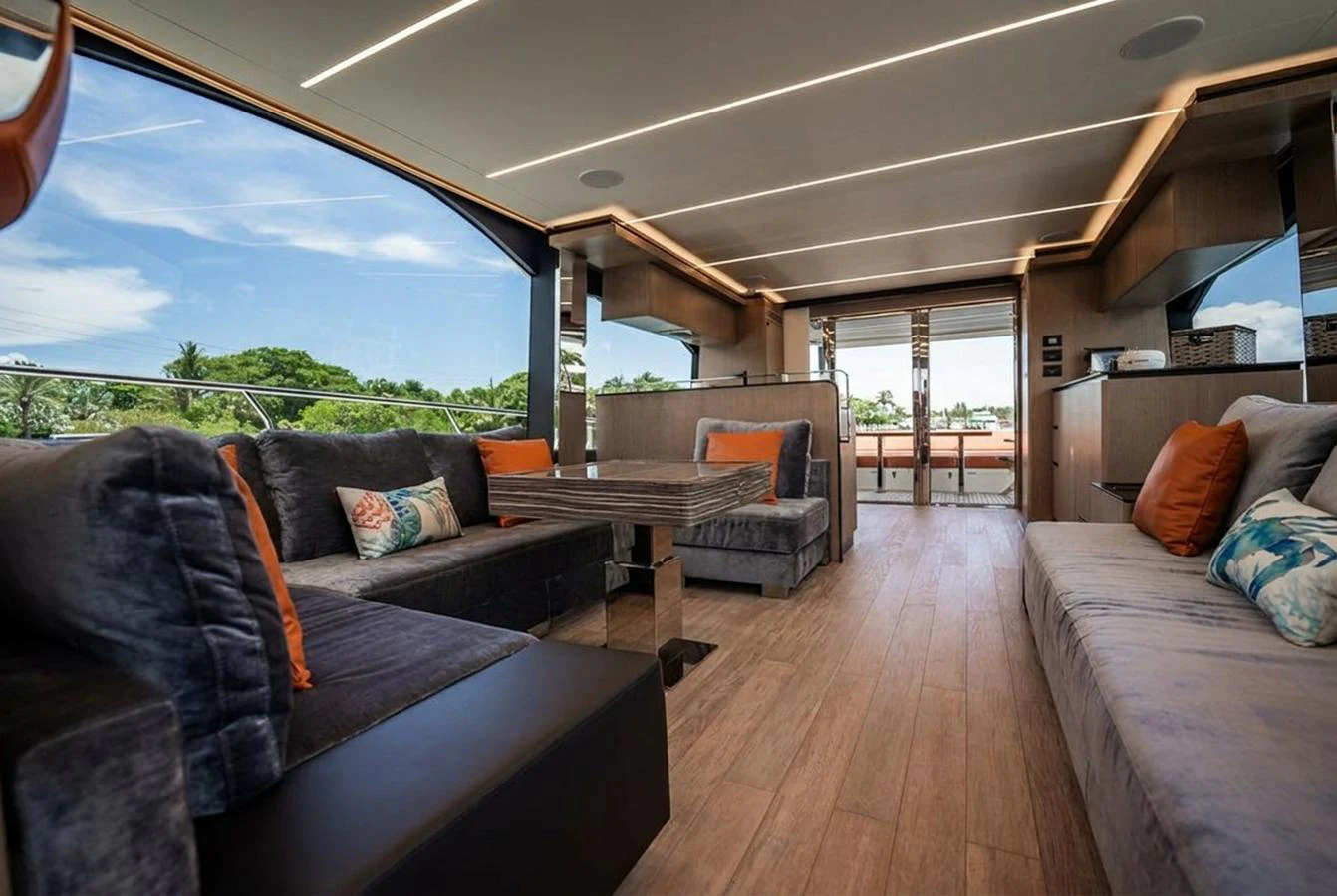 The salon features plush seating, modern decor, and ample natural light. aboard ELENA Yacht for Sale