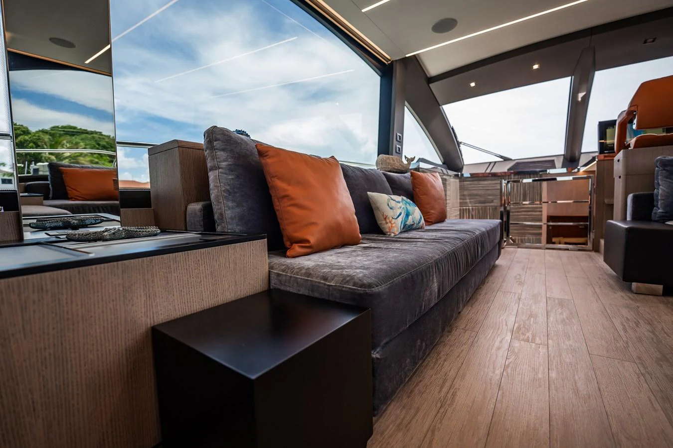 The yacht's salon features a plush sofa with vibrant cushions, offering a comfortable and stylish lounging area. aboard ELENA Yacht for Sale