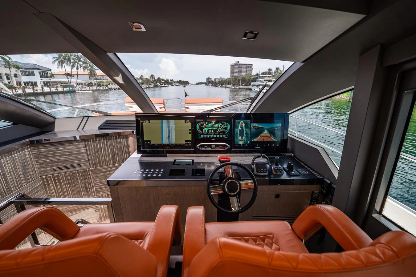 The helm station features modern navigation equipment and luxurious orange seating. aboard ELENA Yacht for Sale