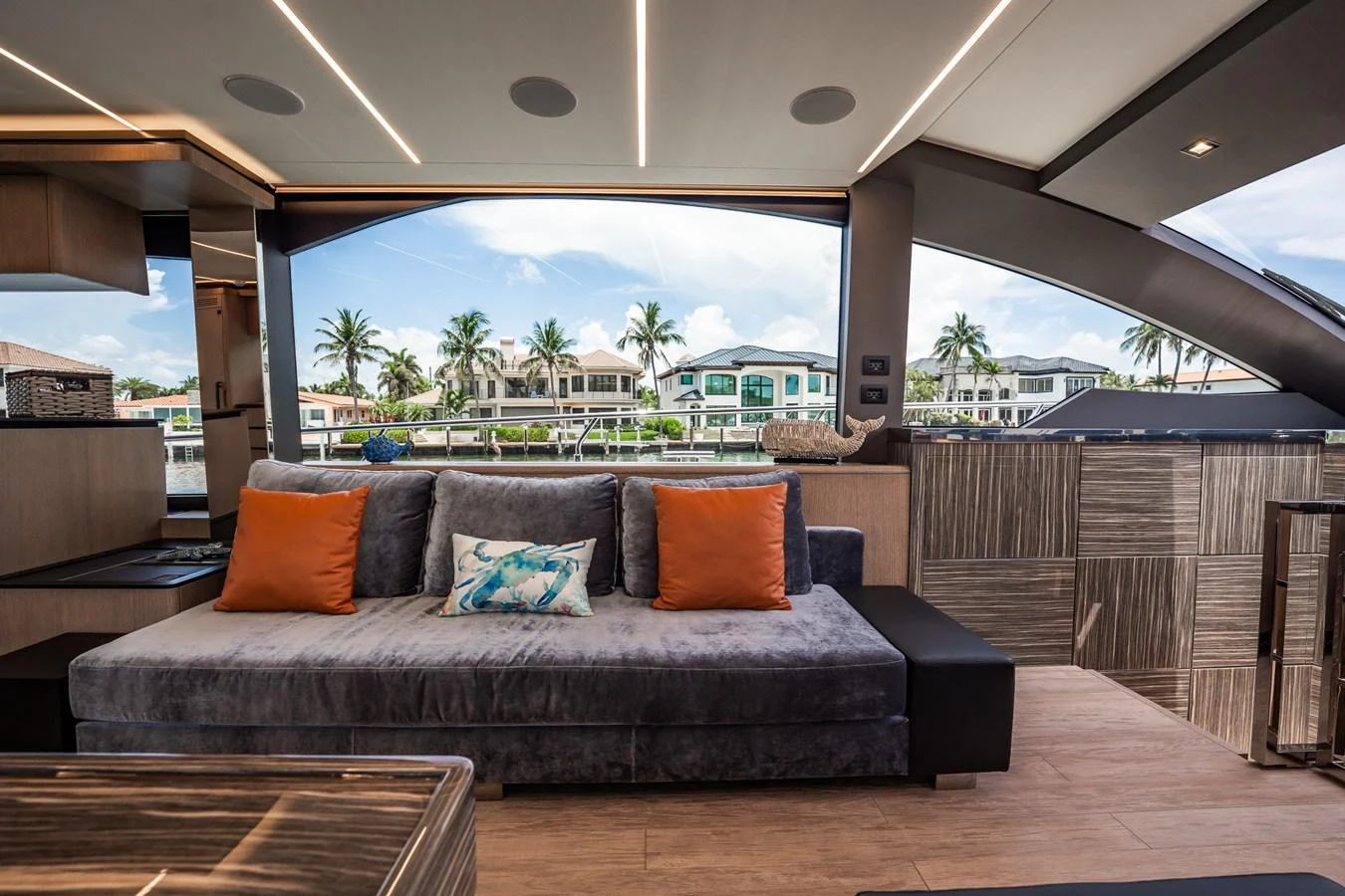 The yacht's interior features a cozy seating area with plush cushions and a view of the waterfront. aboard ELENA Yacht for Sale