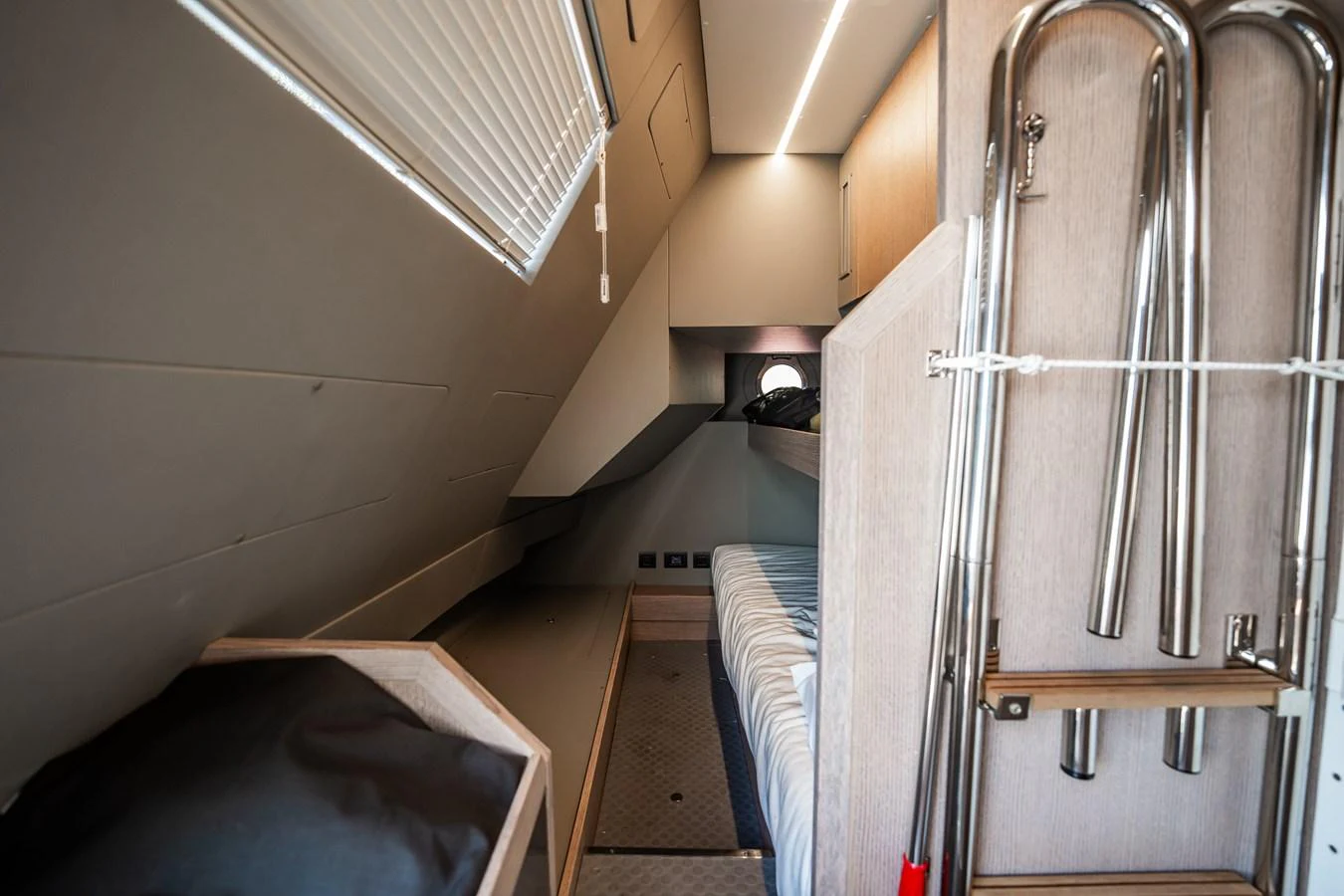 A cozy cabin with a bed and practical storage solutions. aboard ELENA Yacht for Sale