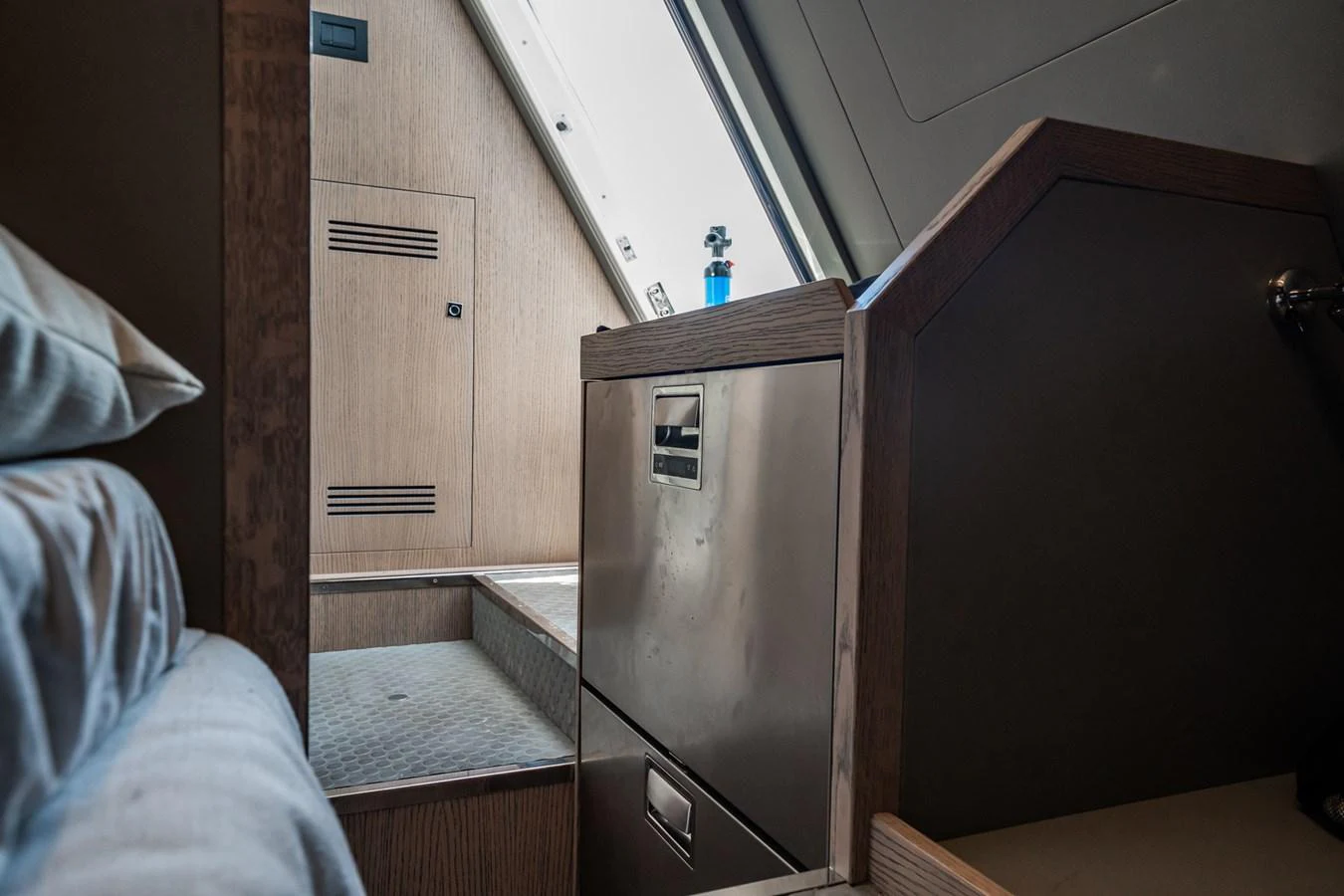 A cozy interior space featuring a bed, storage drawers, and a skylight. aboard ELENA Yacht for Sale