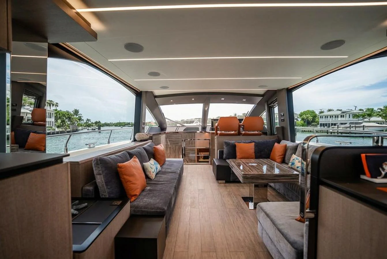 The salon features spacious seating with large windows offering panoramic views. aboard ELENA Yacht for Sale