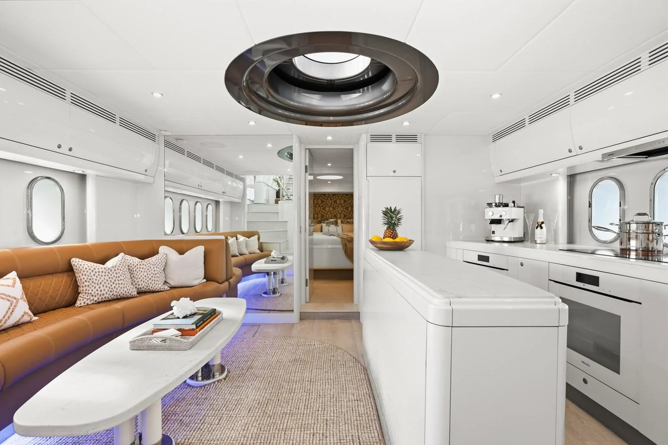 The yacht's salon features a modern design with a comfortable seating area and a well-equipped galley. aboard WARREN 87 Yacht for Sale