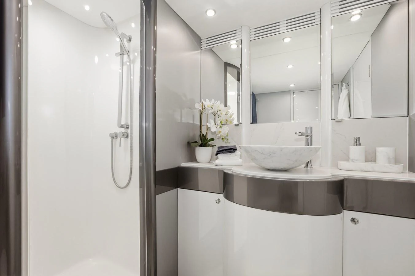 The yacht's bathroom features a sleek, modern design with a spacious shower and elegant fixtures. aboard WARREN 87 Yacht for Sale