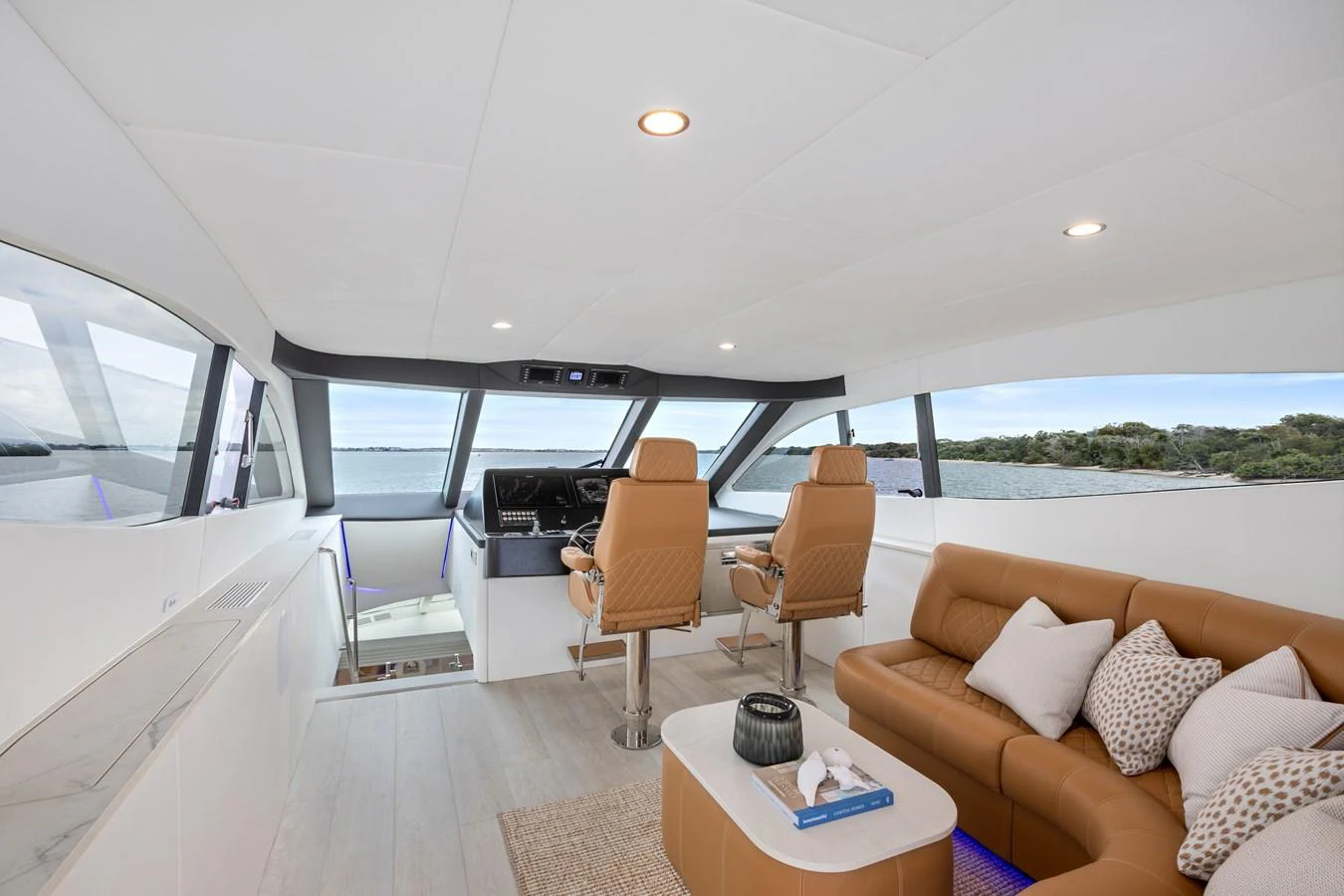 The yacht's helm area features a luxurious seating arrangement with panoramic views. aboard WARREN 87 Yacht for Sale