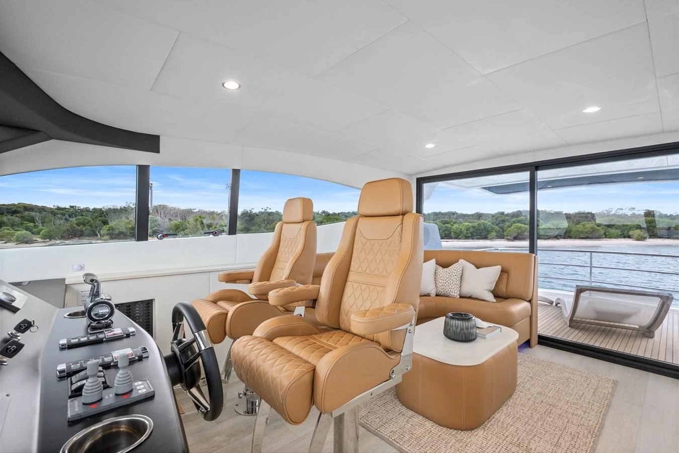 The helm area features luxurious leather seating with panoramic views through large windows. aboard WARREN 87 Yacht for Sale