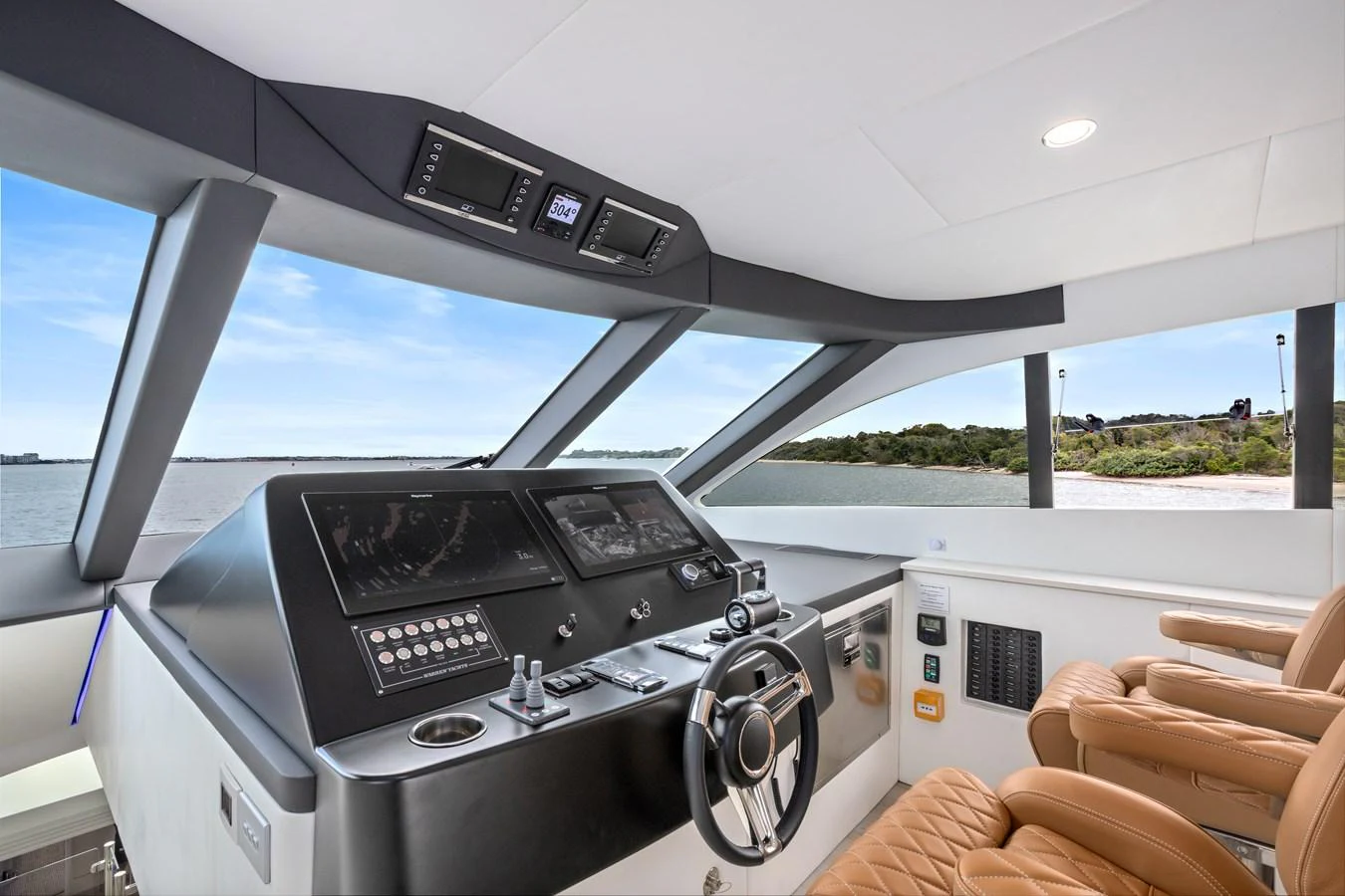 The helm station offers a sleek and modern command center with panoramic views. aboard WARREN 87 Yacht for Sale