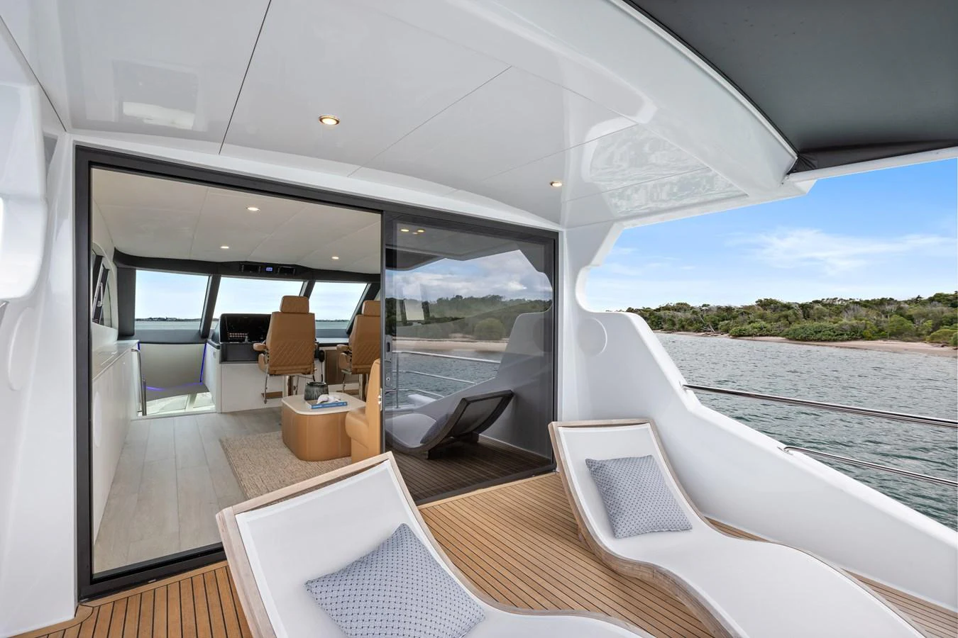 The aft deck offers a seamless transition to the interior with comfortable lounge chairs and a view of the serene waters. aboard WARREN 87 Yacht for Sale