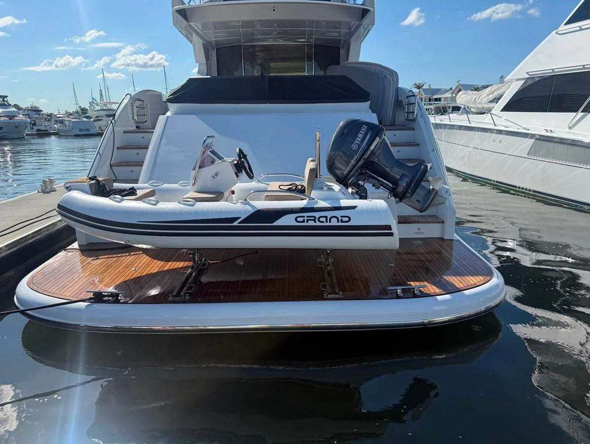 A sleek tender is secured on the aft deck of a luxurious yacht, ready for adventure. aboard WARREN 87 Yacht for Sale