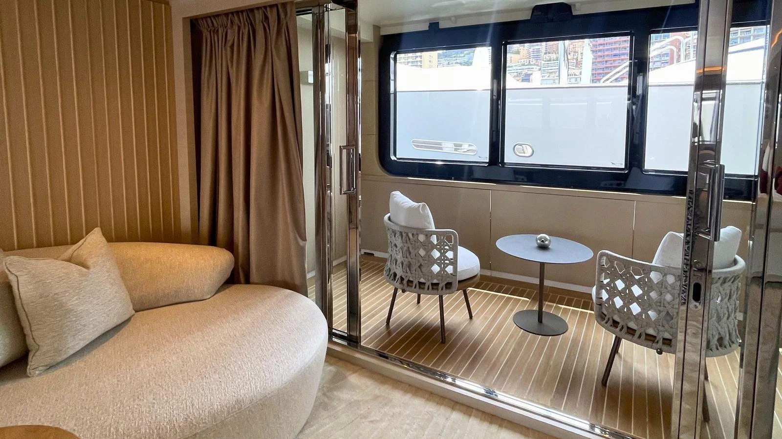 The salon features a cozy seating area with a view of the deck through large windows. aboard ELENI 60M Yacht for Sale