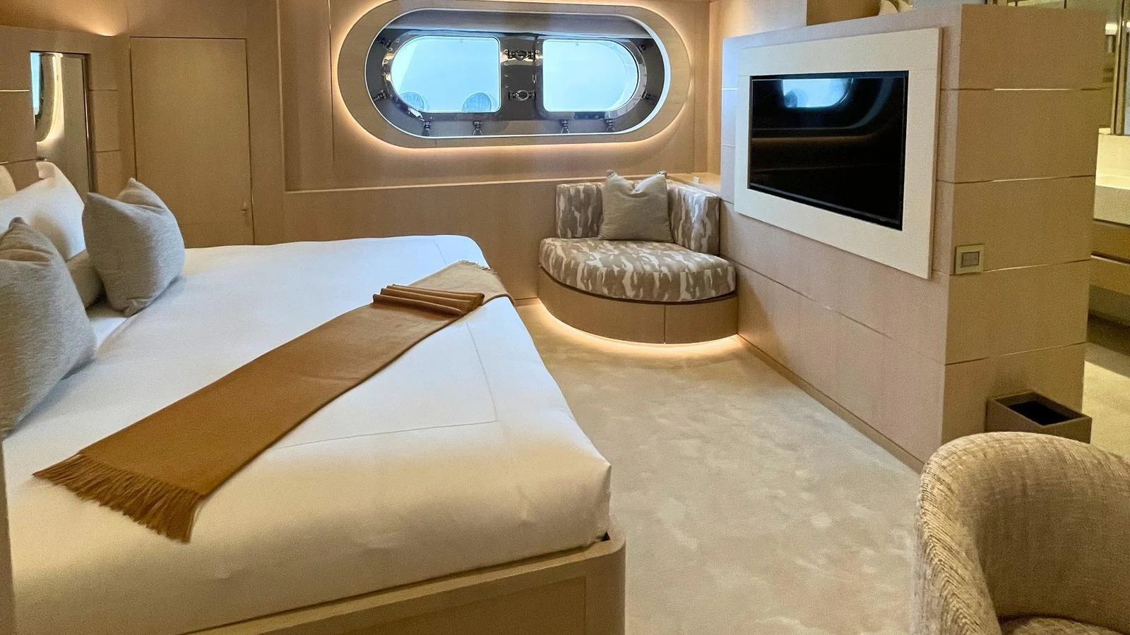 The master stateroom features a plush bed, a cozy seating area, and a large window for natural light. aboard ELENI 60M Yacht for Sale