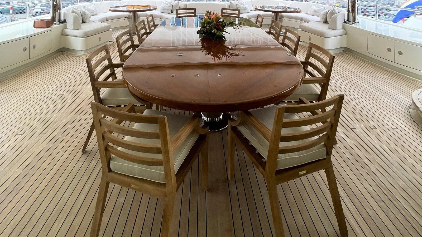 The yacht features a spacious and elegant dining area with a large wooden table and comfortable seating. aboard ELENI 60M Yacht for Sale