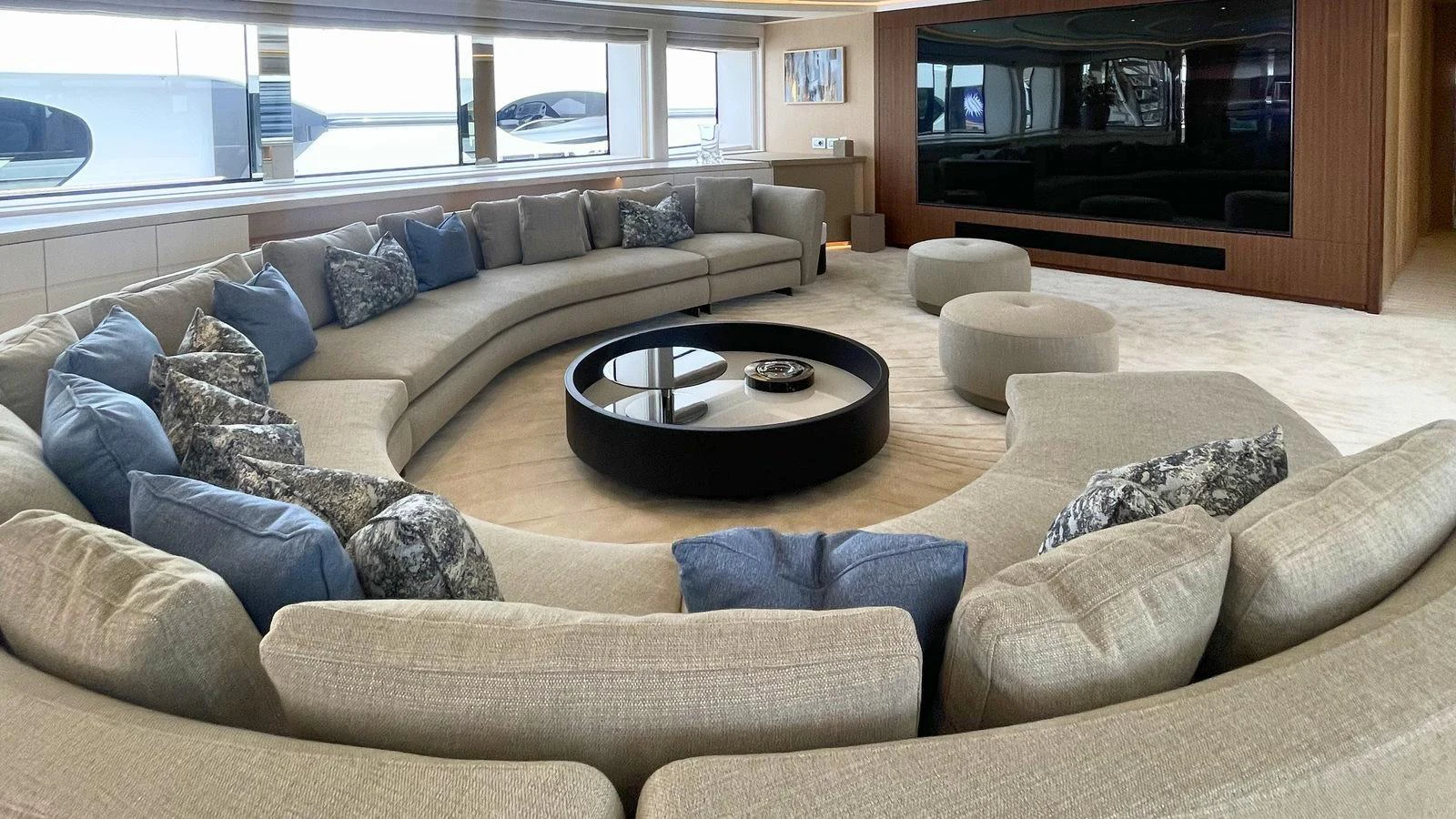The salon features a spacious circular seating arrangement with a modern entertainment system. aboard ELENI 60M Yacht for Sale