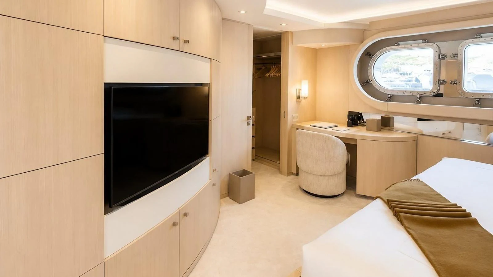 The stateroom features a large television, ample storage, and a cozy seating area by the window. aboard ELENI 60M Yacht for Sale