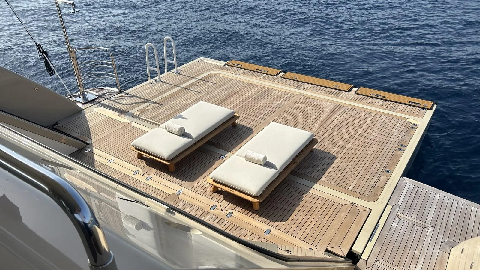 The yacht's swim platform features two luxurious sun loungers with a stunning view of the water. aboard ELENI 60M Yacht for Sale