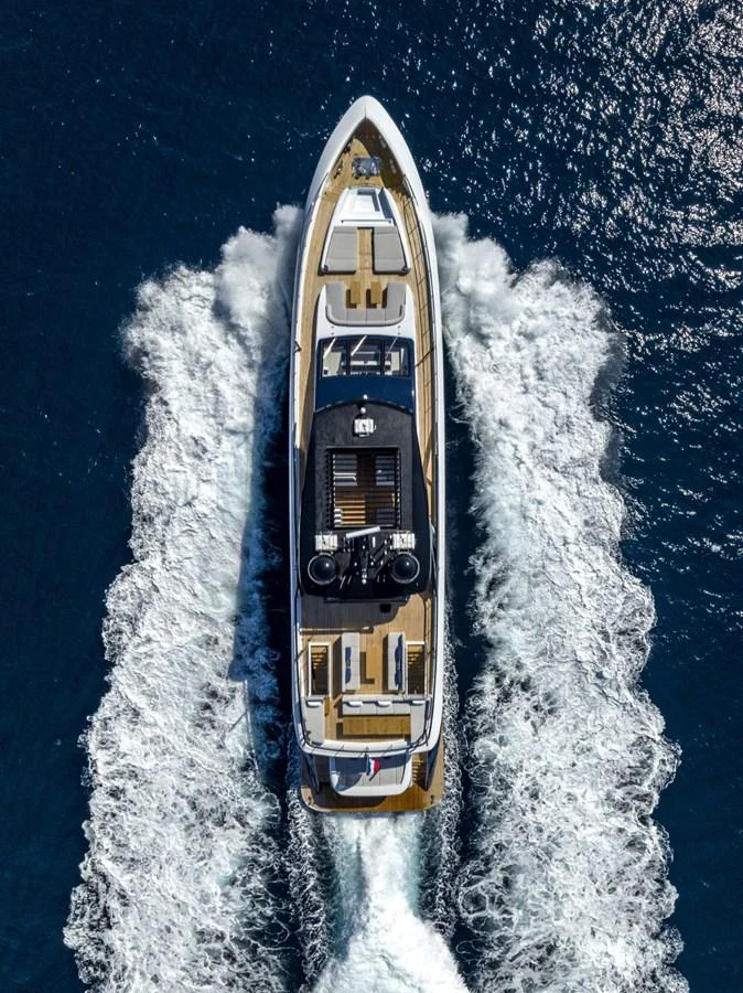 Aerial view of a luxurious yacht cruising through the water, showcasing its sleek design and spacious decks. aboard AMER 120/11 Yacht for Sale