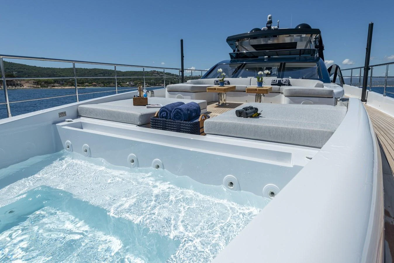 The sundeck features a luxurious jacuzzi with plush seating and a scenic view. aboard AMER 120/11 Yacht for Sale