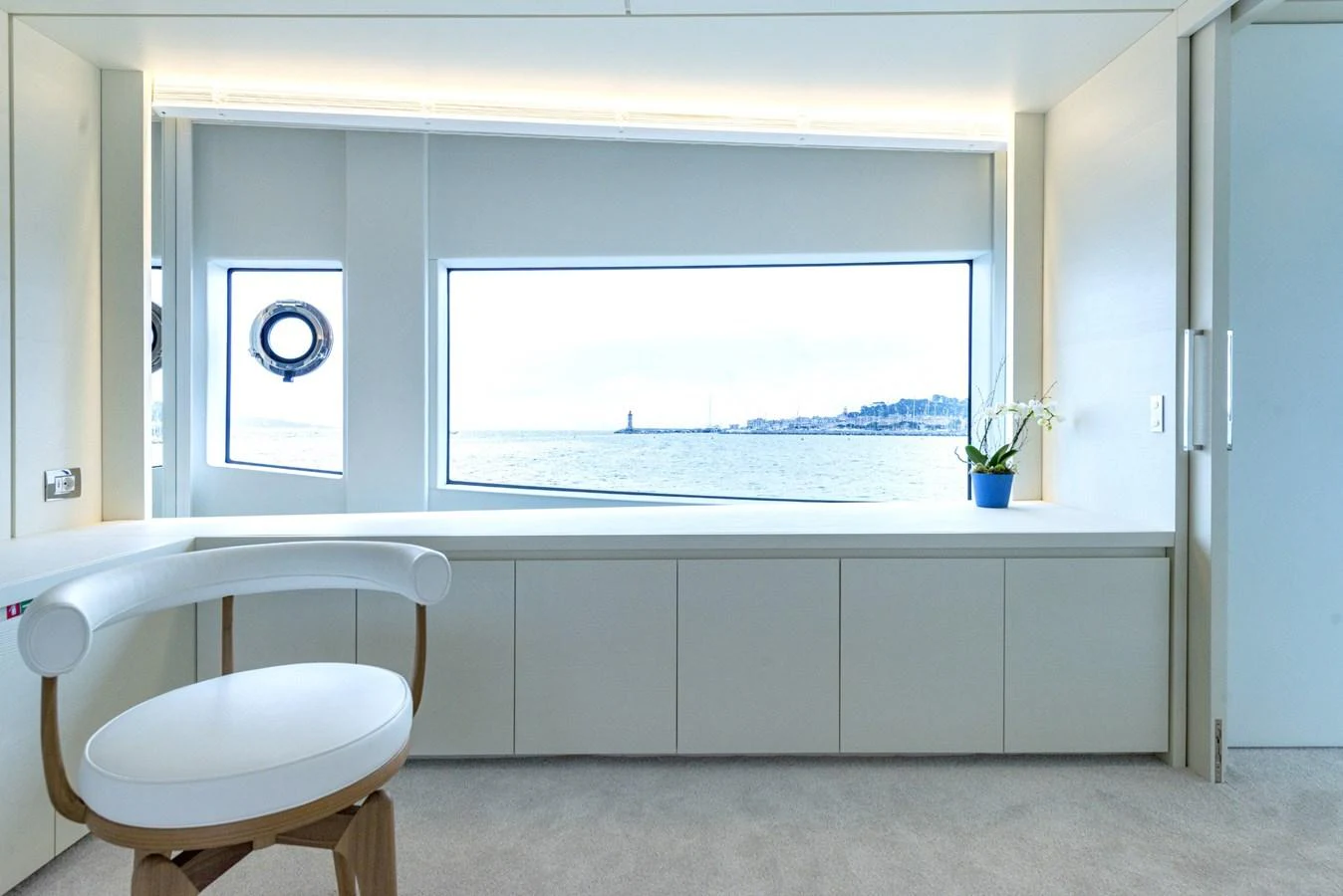 A serene cabin with a large window offering a stunning sea view. aboard AMER 120/11 Yacht for Sale
